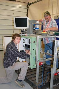 Student and instructor work on adjusting a piece of automation equipment
