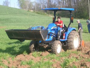 Photo of student on tractor.