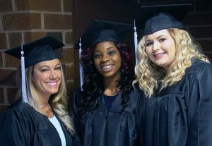 Three smiling female graduates