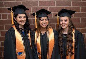 Three smiling female graduates