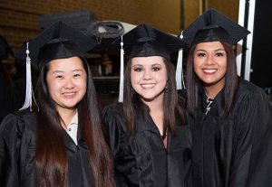Three smiling female graduates