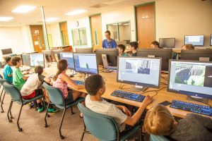 Children at computers during 2018 Sim and Game Camp
