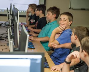 Child smiling at a computer