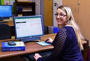 Photo of a smilin WPCC Accounting and Finance student in a computer lab