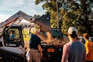 Photo of WPCC consturction students working with scoop machinery and moving earth