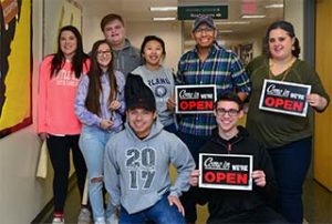Photo of WPCC Business Administration Students holding We Are Open signs