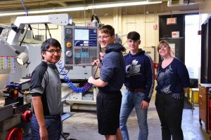 Photo of 4 Burke Middle College Students in the WPCC Machine Shop