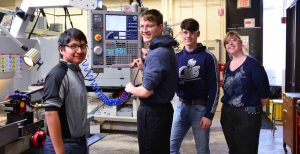 Photo of 4 Burke Middle College Students in the WPCC Machine Shop