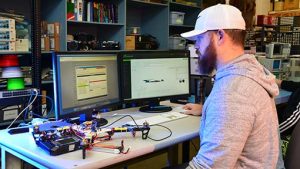 Photo of a WPCC Electronics student working on a drone in the lab