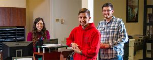 Photo of smiling students at the reception desk in WPCC Student Services