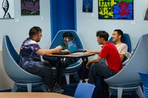 Four WPCC Students work together on computers in the library