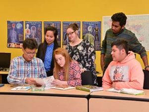 A varied group of WPCC students pose in a lab.