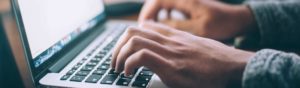 Photo of someone typing on the keyboard of a laptop computer