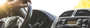Photo of somone holding a steering wheel in a car