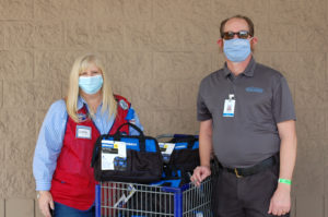 Lana Ramsey and Derrick walker post with a shopping cart full of tool bags outside of Lowe's.