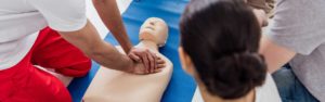 Practice on a CPR Dummy doing chest compressions