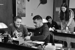 Four students work in the WPCC biology lab on a project