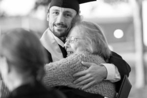 Image of a grad hugging a loved one