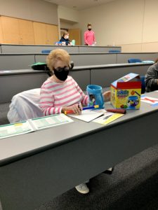Female student in a classroom playing games