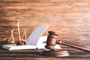 Image of a gavel with a wooden background