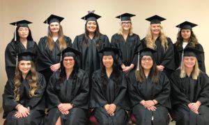 Image of a group of students graduating wearing black cap and gowns