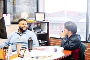 Image of advisor and student talking in an office.
