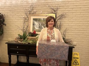 Image of a female holding a gift box.