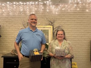 Image of a male and female holding gift boxes.