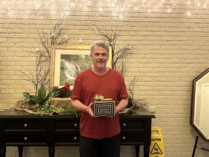 Image of a male holding a gift box.