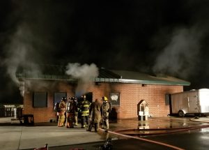 Image of firefighters in a smoky building.