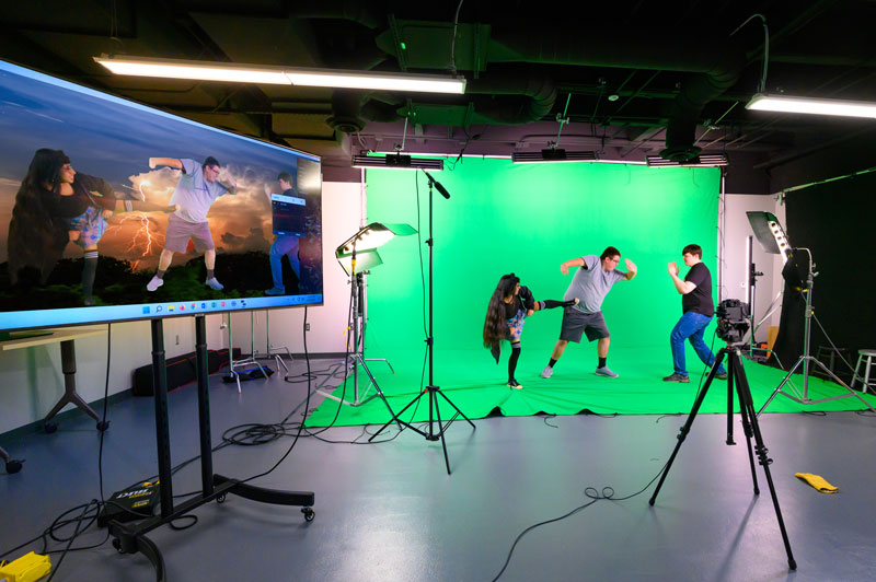 A video camera mounted to a jib is being carried to film a scene