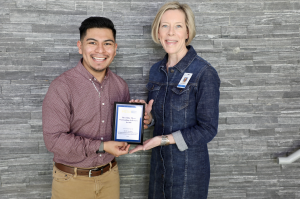 Image of 2 people holding an award.