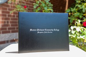 Image of a black Western Piedmont Community College, Morganton, North Carolina diploma holder.