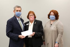 Image of 3 people presenting a DAR scholarship.