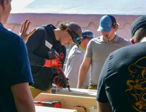 Image of a construction student holding a power tool.