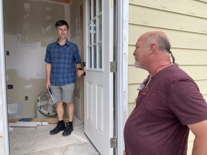 Image of wpcc instructor with a student outside of a mobile home.