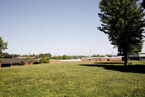 Image of WPCC campus on the grassy commons with the table rock mountains in the background.