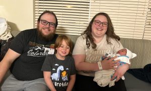 Image of 3 family members with a newborn