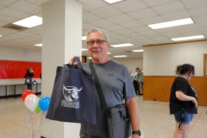 Image of student holding up wpcc ox logo branded tote bag