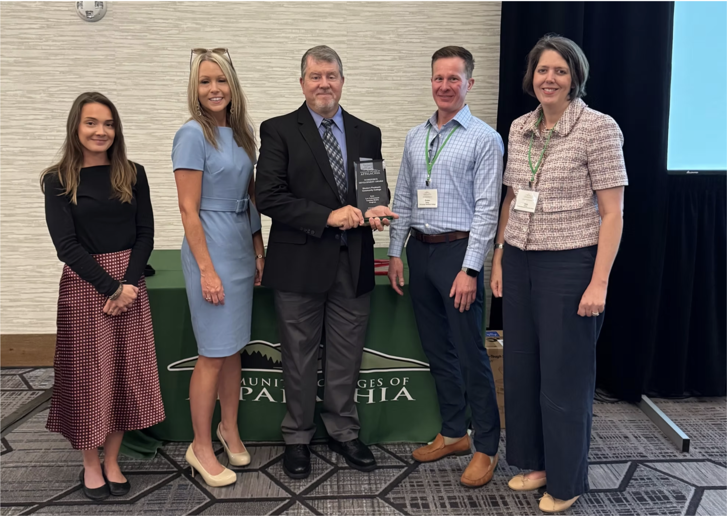 WPCC students and staff smiling together with an award