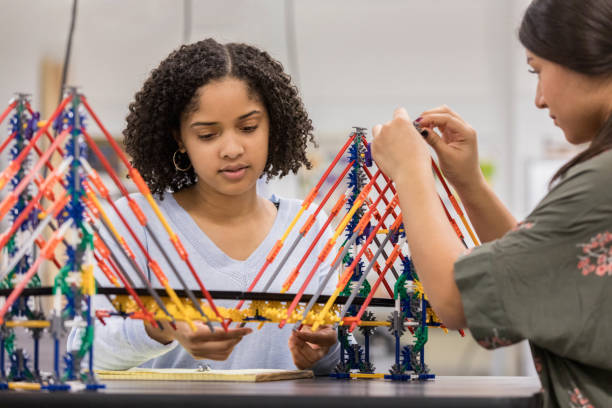 Two teens building a bridge